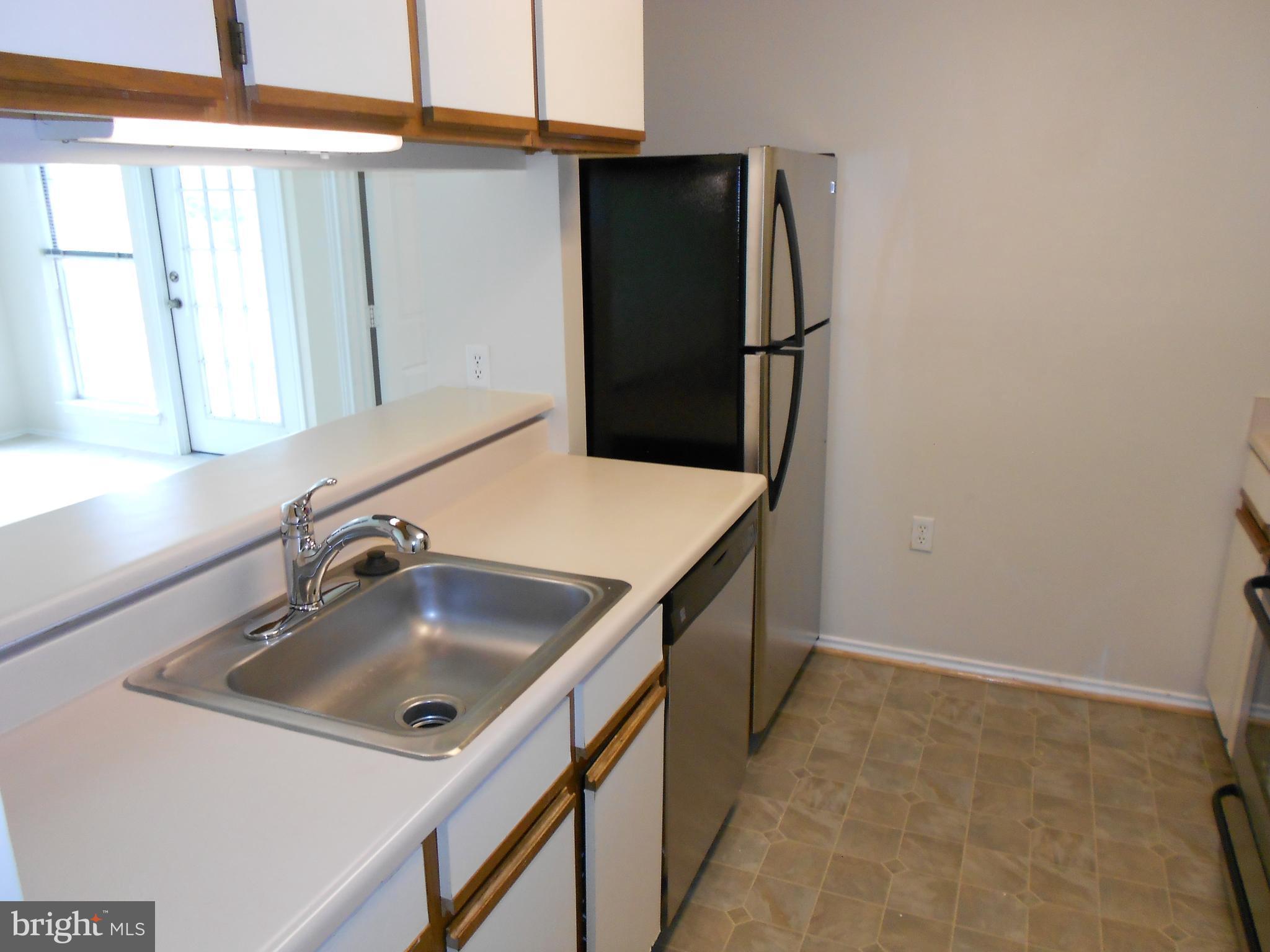 20950 Timber Ridge Terrace, Unit 203 Ashburn, VA 20147 - Photo 6 of 30 a bathroom with a sink and a mirror