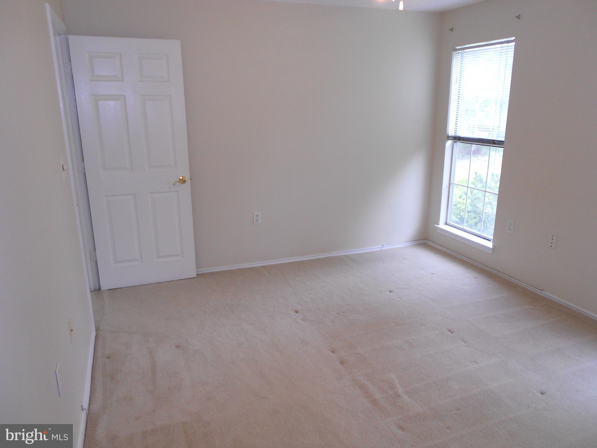 20950 Timber Ridge Terrace, Unit 203 Ashburn, VA 20147 - Photo 10 of 30 an empty room with windows