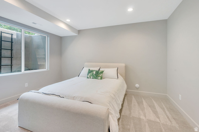 250 South Main Street, Unit 10 Alpine, UT 84004 - Photo 23 of 29 Recessed lighting illuminates this room featuring light gray walls, plush patterned carpeting, and a large egress window