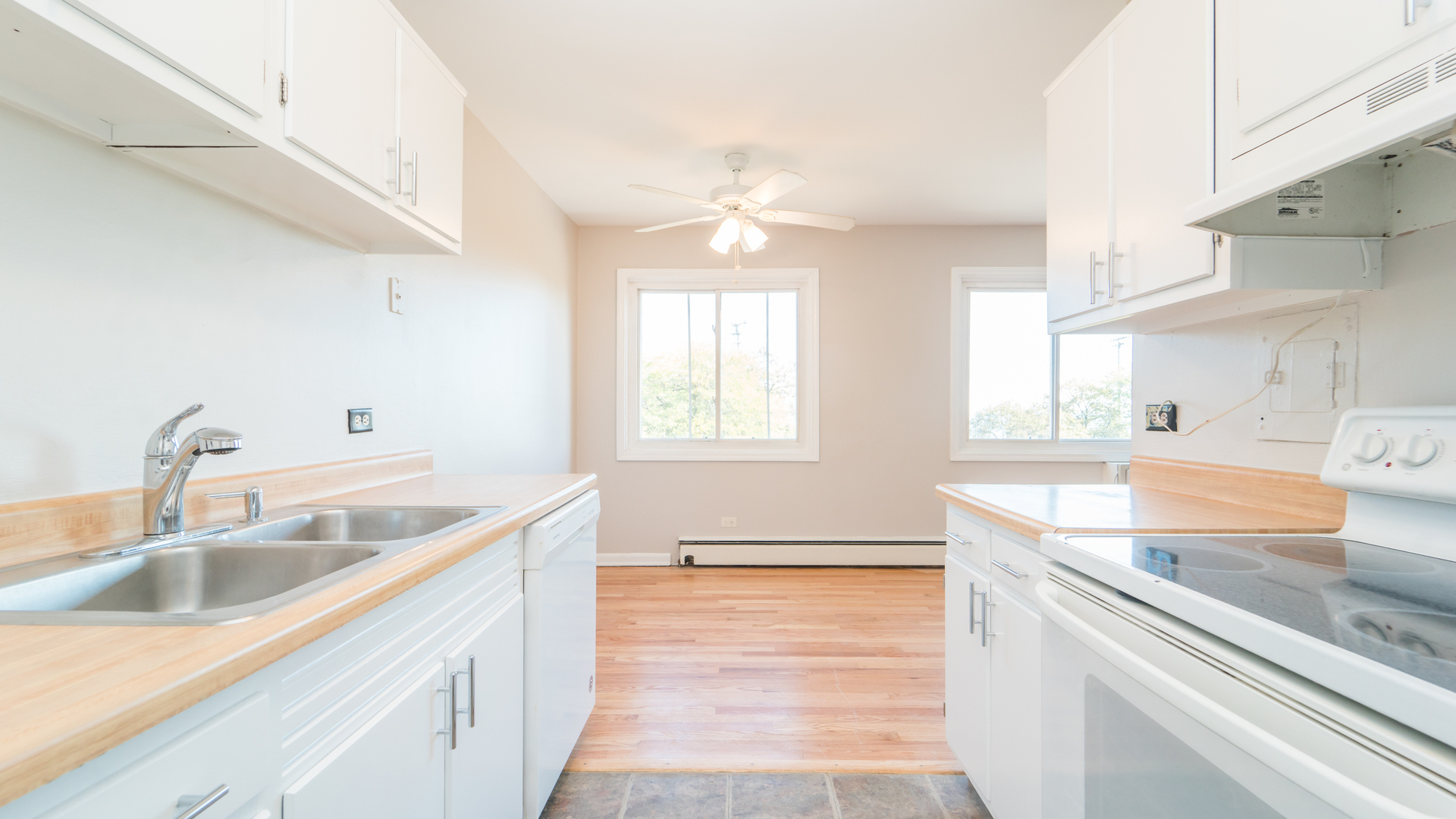 7120 North Sheridan Road, Unit 401 Chicago, IL 60626 - Photo 5 of 9 a kitchen with a sink stove and cabinets