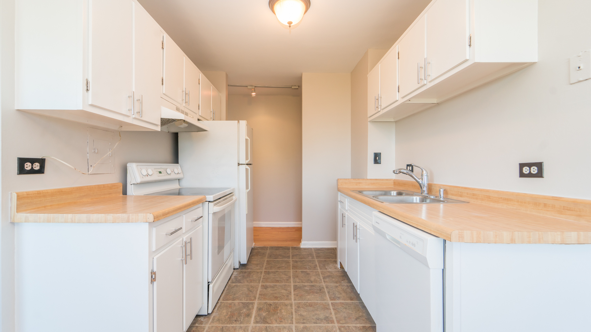 7120 North Sheridan Road, Unit 401 Chicago, IL 60626 - Photo 6 of 9 a kitchen with a sink stove and cabinets