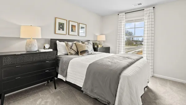 a bedroom with a bed and a night stand