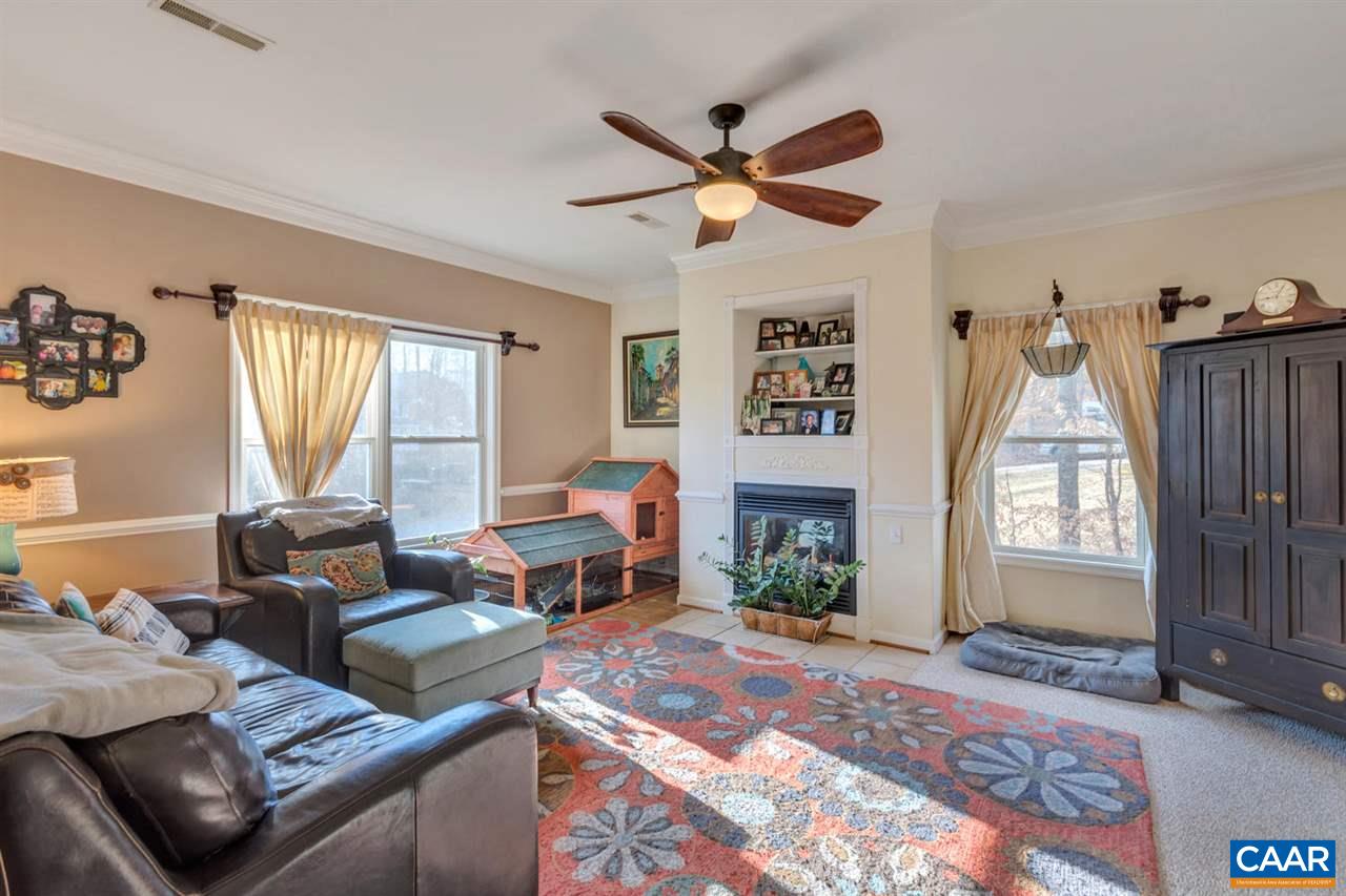 25 Riverside Drive Palmyra, VA 22963 - Photo 6 of 49 a living room with furniture and a fireplace