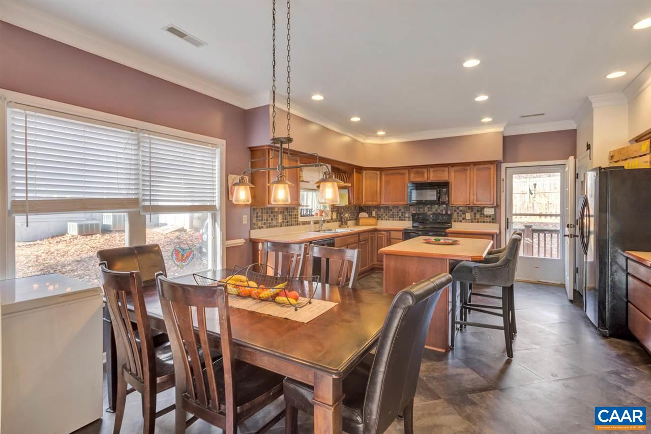 25 Riverside Drive Palmyra, VA 22963 - Photo 8 of 49 a dining room with stainless steel appliances kitchen island granite countertop a dining table and chairs