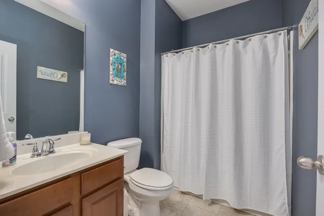 a front view of a house with a yard outdoor seating and mountain view in back