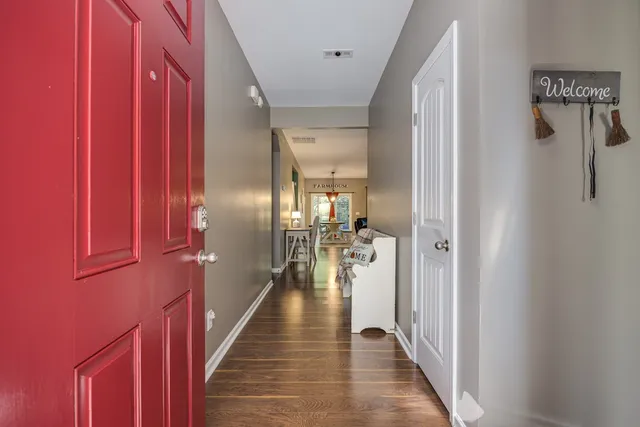 a kitchen with stainless steel appliances kitchen island granite countertop a refrigerator a stove top oven a sink dishwasher and a dining table with the kitchen view