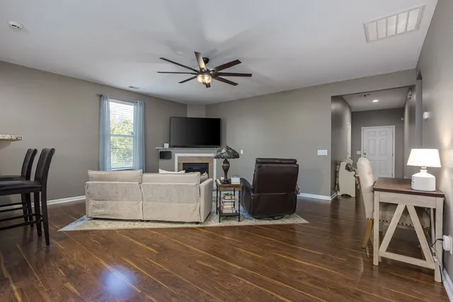 a kitchen with a sink and a stove top oven with wooden floor
