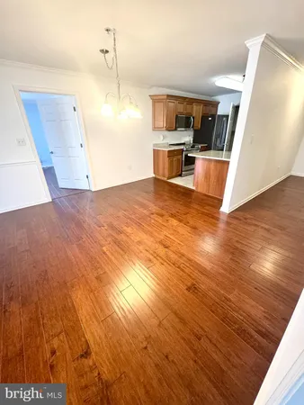 a view of a kitchen with wooden floor