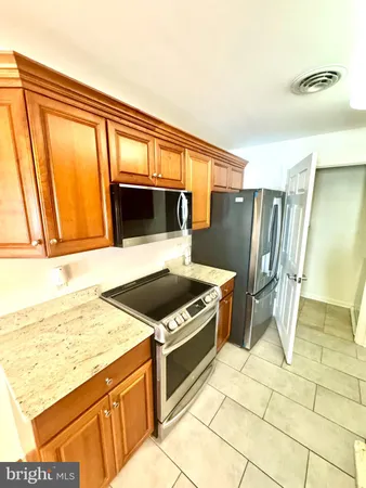 a kitchen with a stove a sink and a refrigerator