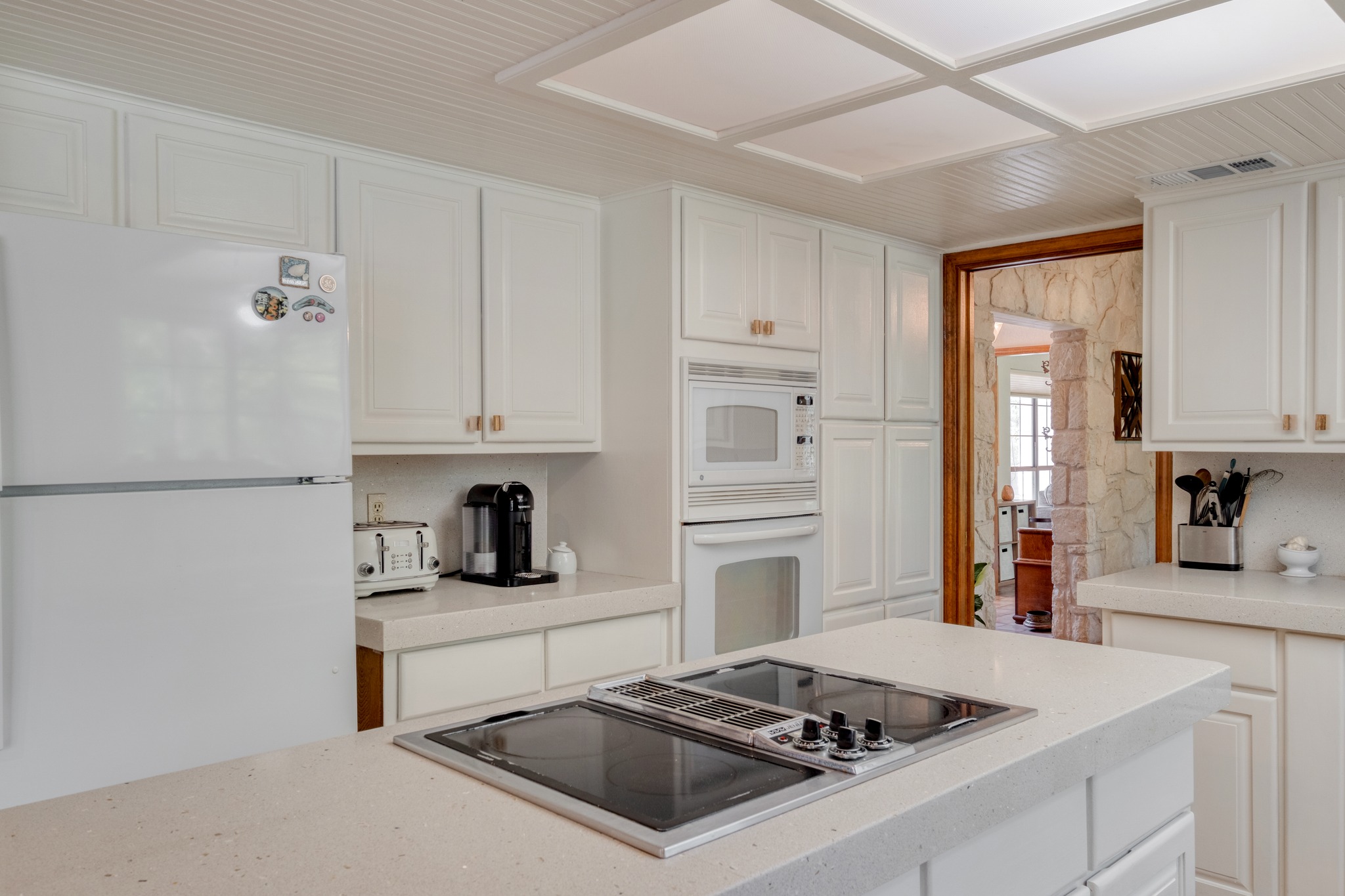 202 Ridgewood Drive Georgetown, TX 78628 - Photo 12 of 40 a kitchen with white cabinets and appliances