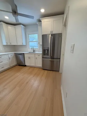 a kitchen with stainless steel appliances a refrigerator and a sink