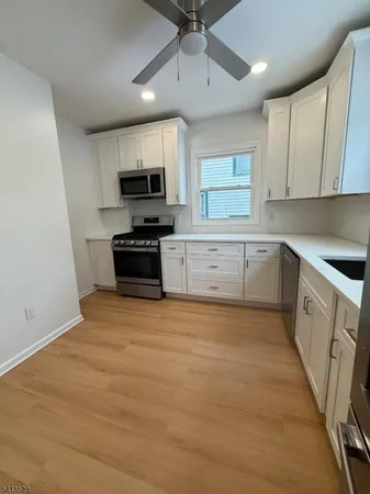 a kitchen with granite countertop a stove and a sink