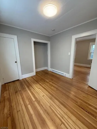 a view of an empty room and wooden floor