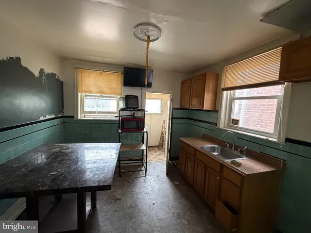 a kitchen with a table chairs and a stove