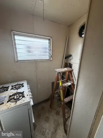 a utility room with dryer washer and stair
