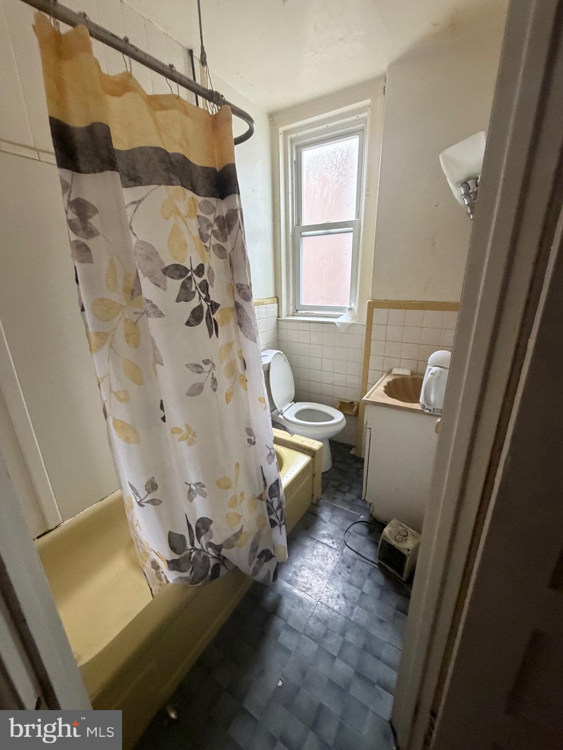 6054 North American Street Philadelphia, PA 19120 - Photo 7 of 10 a bathroom with a toilet and a shower