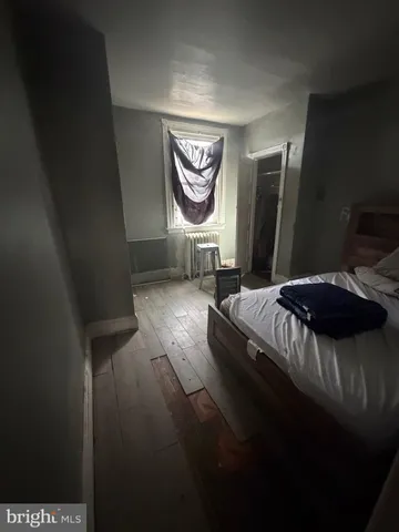 a bedroom with a bed and a mirror