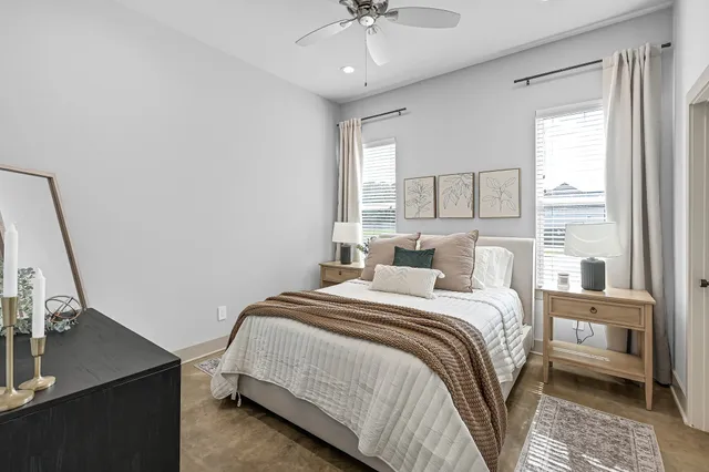 a bedroom with a bed window and a table