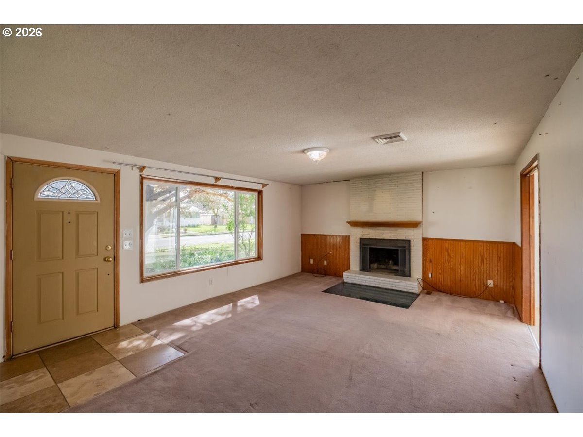 341 Northeast Cambridge Circle Corvallis, OR 97330 - Photo 3 of 46 a view of an empty room with a fireplace and a window