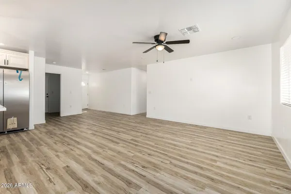 a view of empty room with wooden floor