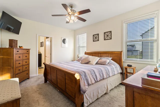 a bedroom with a bed and a television