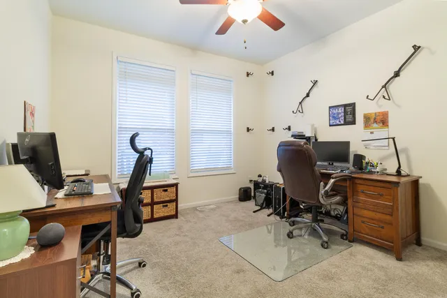 a view of a workspace with furniture and a window