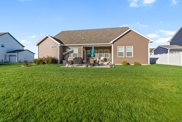 a front view of house with yard and green space
