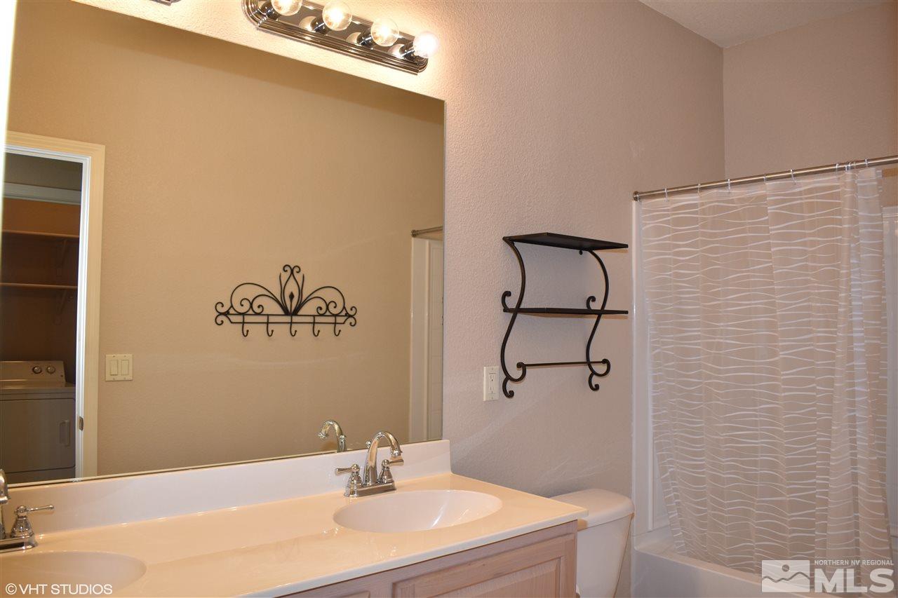 1895 Stetson Drive Reno, NV 89521 - Photo 18 of 24 a bathroom with a sink vanity mirror and shower