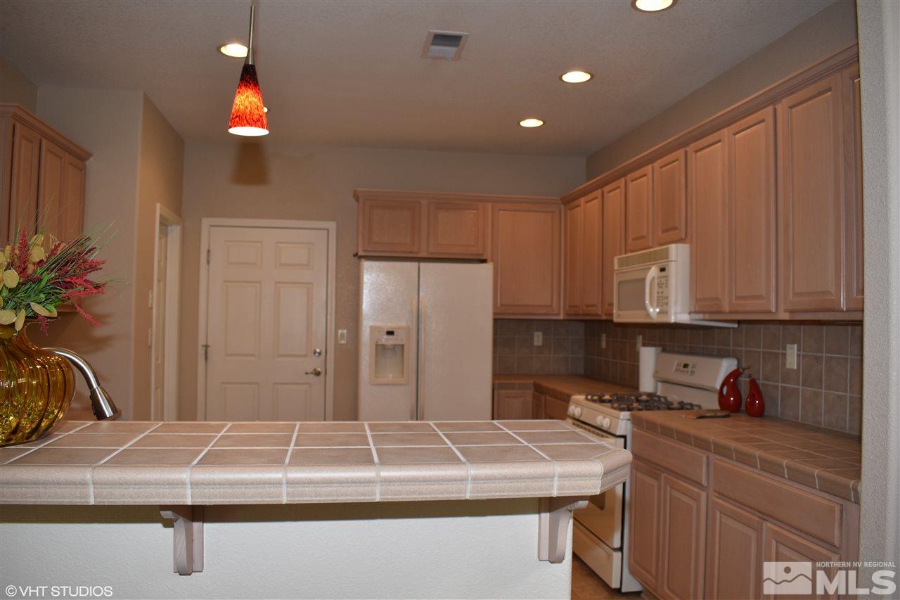 1895 Stetson Drive Reno, NV 89521 - Photo 7 of 24 a kitchen with a refrigerator and a sink