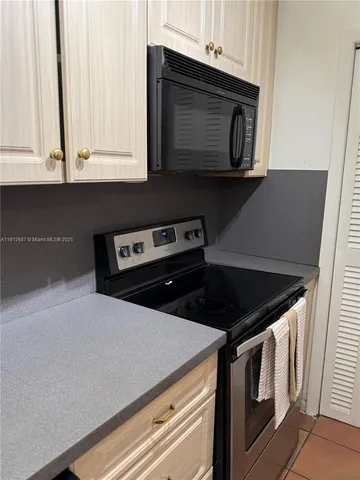 a kitchen with a stove microwave and cabinets