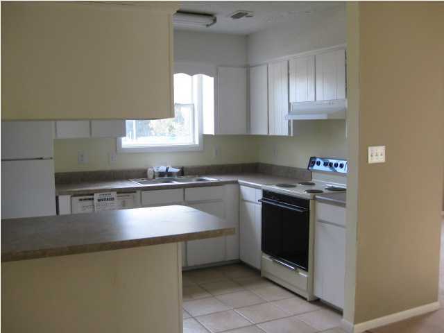 6216 Winstead Road Crestview, FL 32539 - Photo 3 of 10 a kitchen with stainless steel appliances granite countertop a sink stove and microwave