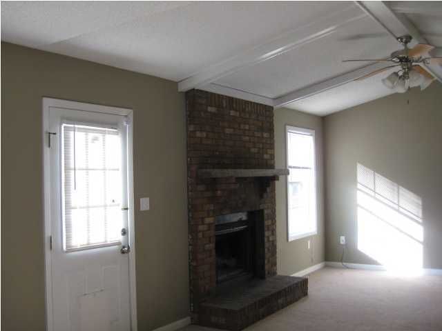 6216 Winstead Road Crestview, FL 32539 - Photo 5 of 10 an empty room with windows and fireplace