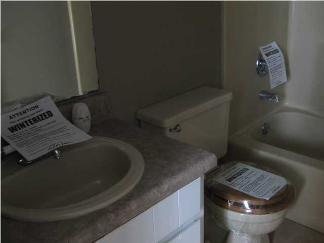 6216 Winstead Road Crestview, FL 32539 - Photo 8 of 10 a bathroom with a toilet sink and mirror