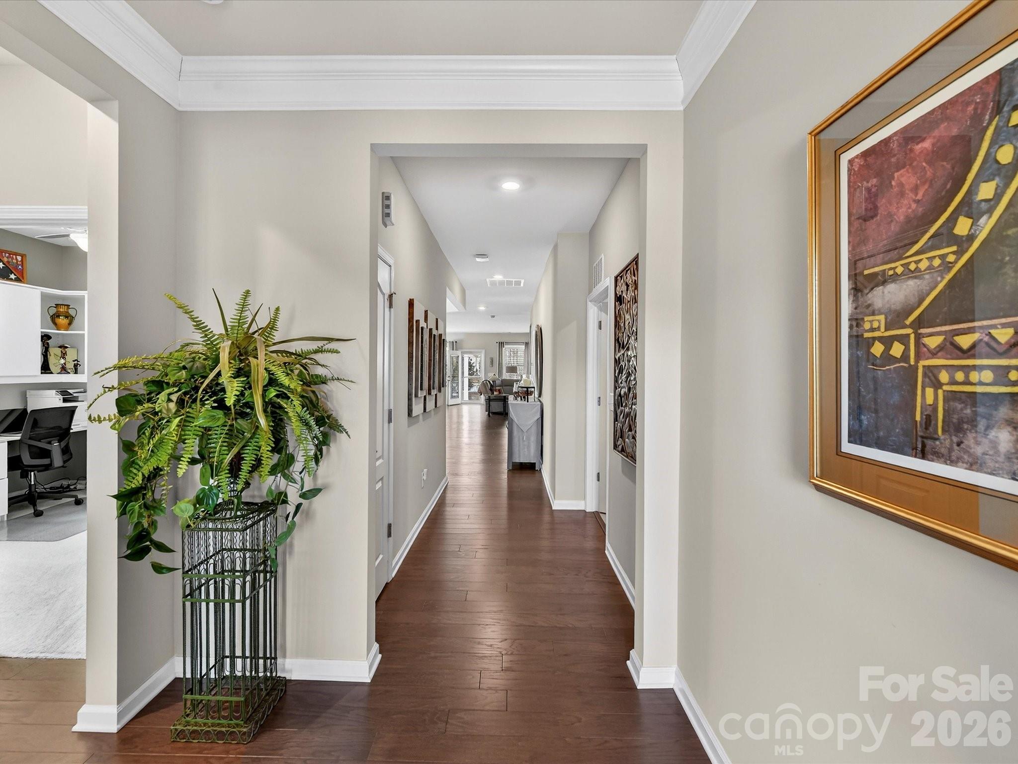 3355 Oliver Stanley Trail Lancaster, SC 29720 - Photo 4 of 48 a hallway with painting on the wall and a potted plant