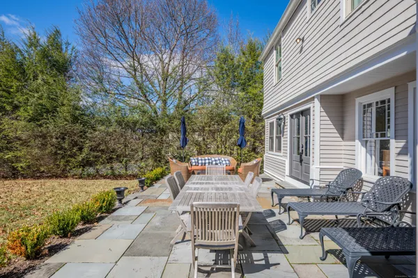 a view of a patio with couches table and chairs and potted plants