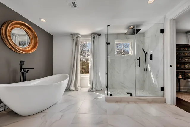 a bathroom with a bathtub and a shower