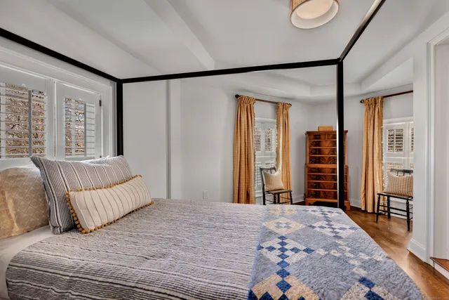 a bedroom with a large bed and a window