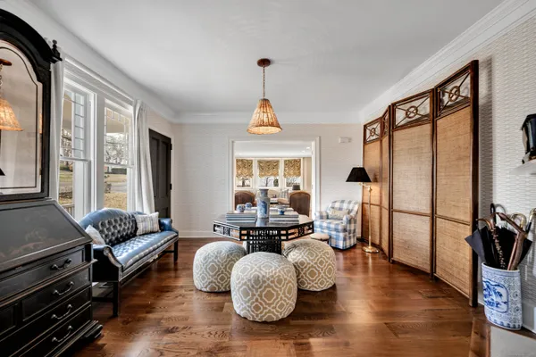 a living room with furniture a flat screen tv and a large window