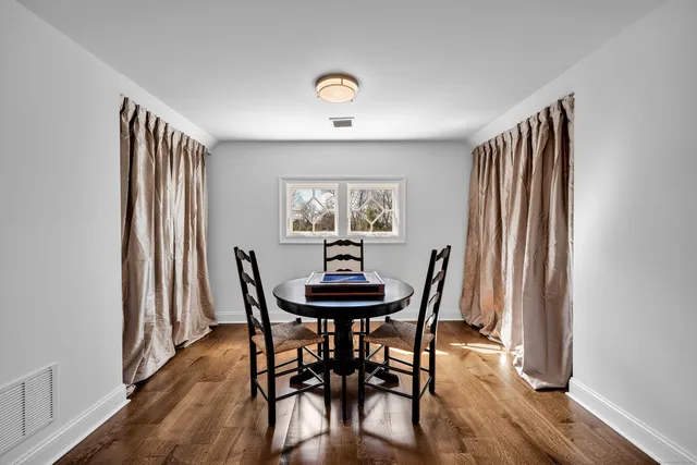 a dining room with furniture and window