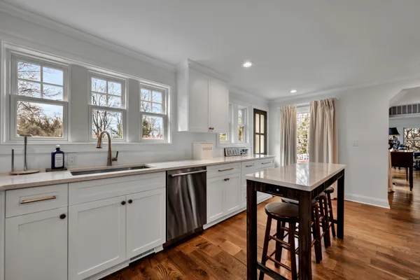 a kitchen with center island table and chairs