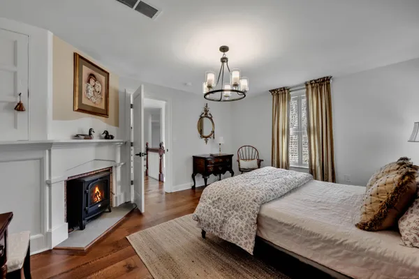 a bedroom with a bed and a fireplace