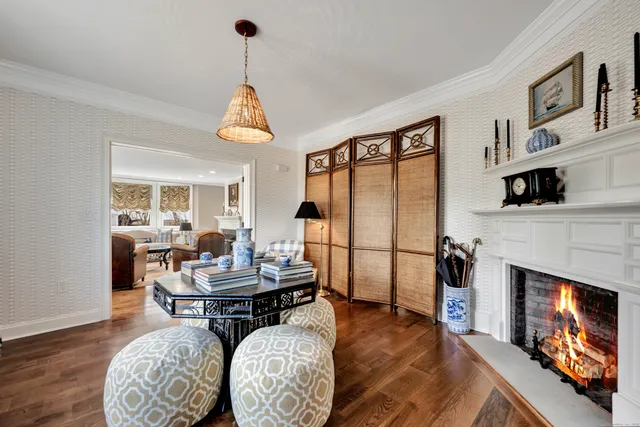 a living room with furniture a fireplace and a table