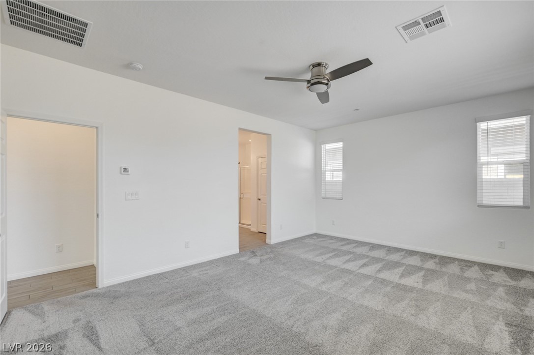 756 Cadence View Way Henderson, NV 89011 - Photo 12 of 45 Unfurnished bedroom featuring light carpet and ceiling fan