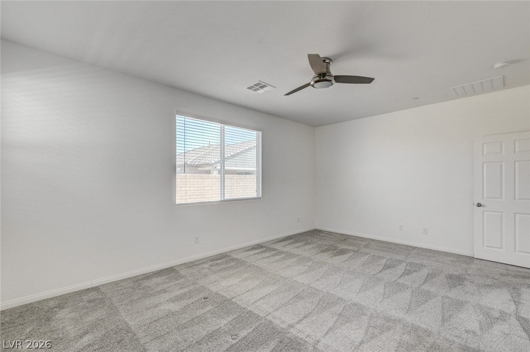 756 Cadence View Way Henderson, NV 89011 - Photo 14 of 45 Unfurnished room featuring light colored carpet and ceiling fan