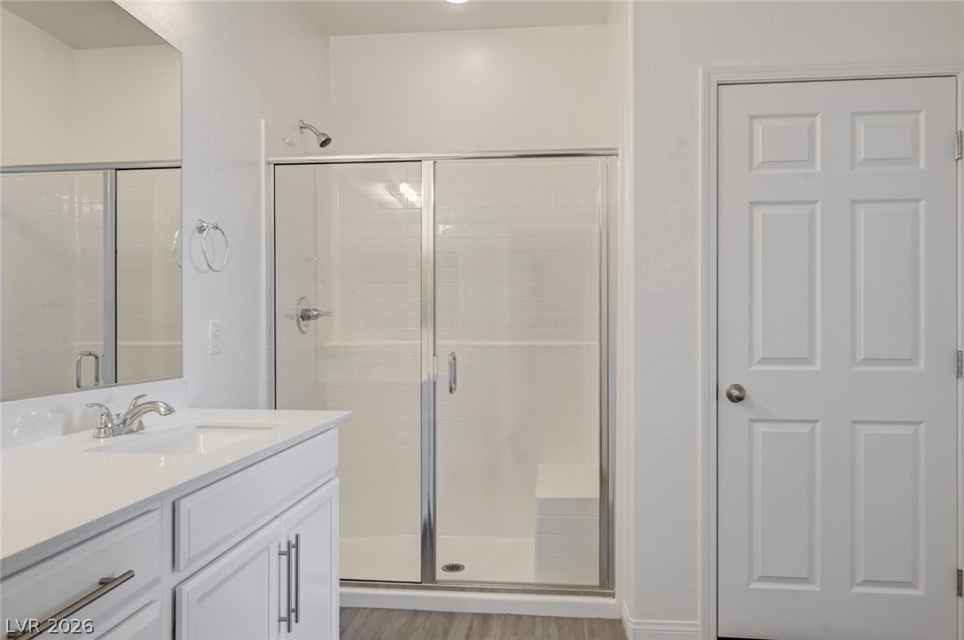 756 Cadence View Way Henderson, NV 89011 - Photo 17 of 45 Bathroom featuring vanity, a shower stall, and light wood-style floors