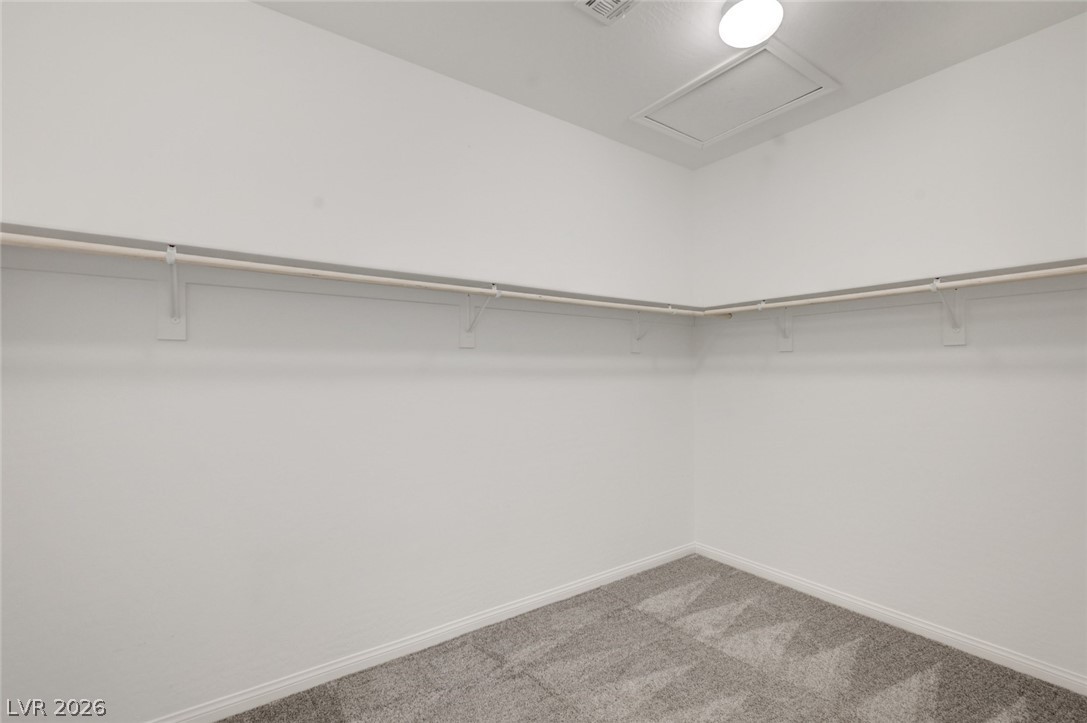 756 Cadence View Way Henderson, NV 89011 - Photo 18 of 45 Walk in closet featuring attic access and carpet flooring
