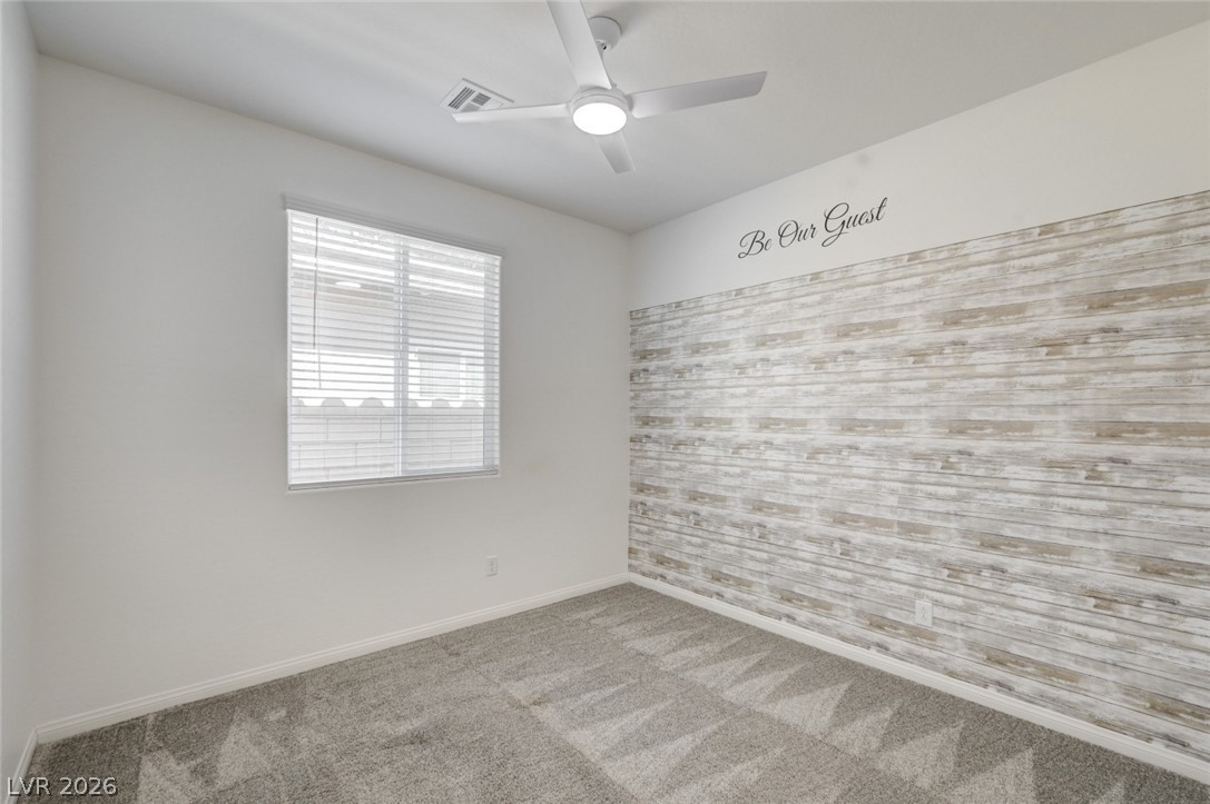 756 Cadence View Way Henderson, NV 89011 - Photo 19 of 45 Spare room featuring a ceiling fan and light colored carpet