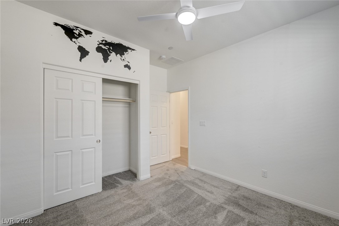 756 Cadence View Way Henderson, NV 89011 - Photo 21 of 45 Unfurnished bedroom featuring light carpet, ceiling fan, and a closet