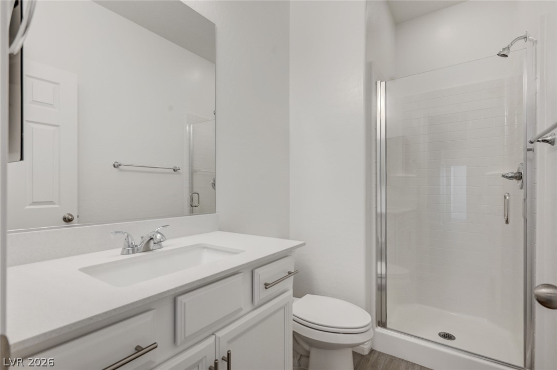 756 Cadence View Way Henderson, NV 89011 - Photo 22 of 45 Bathroom with vanity, a stall shower, and light wood finished floors