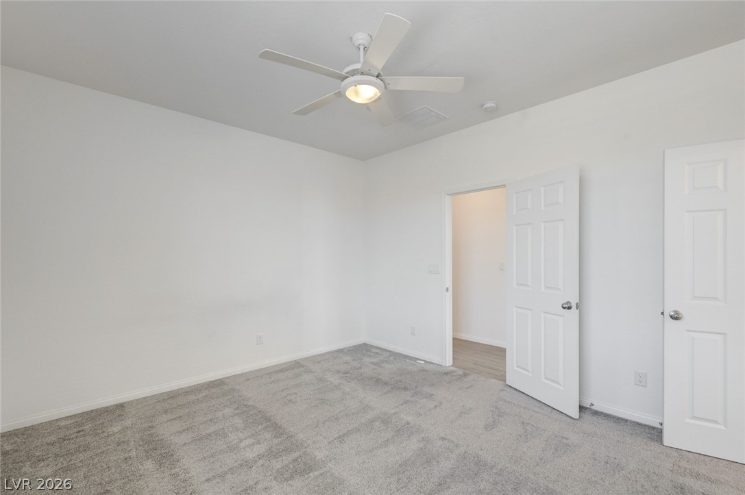 756 Cadence View Way Henderson, NV 89011 - Photo 30 of 45 Unfurnished bedroom featuring light carpet and a ceiling fan